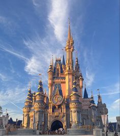 a large castle with a clock on it's face in front of a blue sky