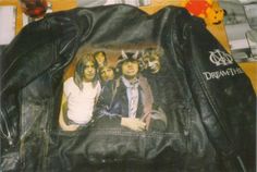 a leather jacket with an image of the band nirvana on it