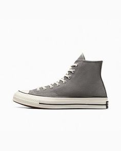 Elevate your sneaker game with these Converse Chuck 70 Hi Vintage Canvas Origin Story sneakers in gray. These high top sneakers feature a lace-up closure and a solid pattern with star and sports themes. The upper material is made of canvas, while the outsole material is rubber. The shoe width is D, and the size is 11 for both the UK and US, and 45 for EU. The shoes are perfect for walking and basketball, with features such as cushioning, comfort, and breathability. The lining material is also ma Converse High Tops Gray, Gray Leather Converse Sneakers, Casual Gray Converse High-top Sneakers, Grey High Top Converse, Charcoal Converse, Converse Chuck 70, Chuck 70, Sneaker Games, Vintage Canvas