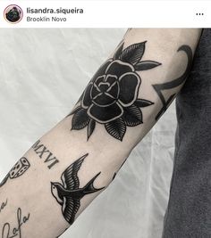 a man's arm with tattoos on it and an image of a rose in the middle