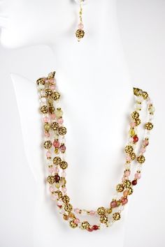 Style and luxury are embodied in this lovely and fashionable three strand round cherry quartz beads necklace. Gold Bali bead and rondelles, with Swarovski© crystals are adorned with an adjustable gold chain and lobster claw clasp Let loose in the evening with a cocktail dress or classic cocktail wear. Let it sparkle under warm candlelight. After all, you're worth it. Elegant Gold Beaded Necklaces For Evening, Party Multi-strand Crystal Necklaces With Faceted Beads, Multi-strand Faceted Beads Crystal Necklace For Party, Multi-strand Faceted Beads Crystal Necklaces For Party, Elegant Multi-strand Beaded Crystal Necklace, Elegant Multi-strand Beaded Crystal Necklaces, Elegant Beaded Multi-strand Crystal Necklace, Elegant Beaded Multi-strand Crystal Necklaces, Elegant Double Strand Crystal Necklace With Faceted Beads