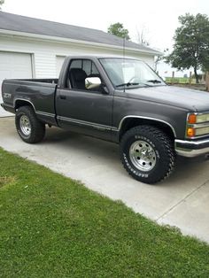 a gray truck parked in front of a house