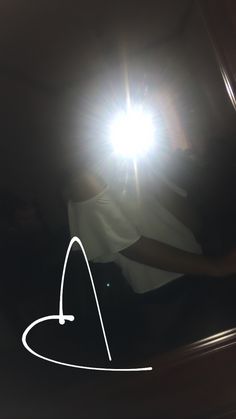 the reflection of a person's head in a mirror with light coming through it