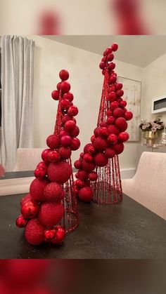 two red christmas trees sitting on top of a table