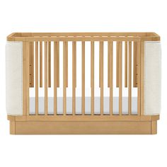 a wooden crib with white sheets on the bottom and side panels, in front of a white background