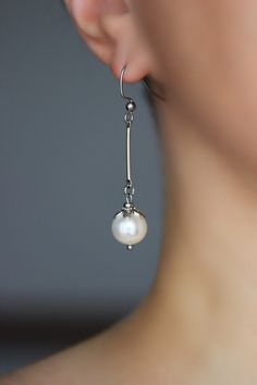 Pretty feminine earrings with high quality white pearl coated 10 mm beads, silver tone flower shape bead caps, silver tone metal stick connectors and stainless steel earring hooks. Earring hooks are from nickel free and lead free metal. *The total lenght of earrings is about 54 mm including earring hooks. Perfect jewelry for everyday wear or a wonderful gift! Other earrings of my shop you can see here: https://www.etsy.com/shop/NaTavelli?section_id=13757927 Thanks for visit. Minimalist Nickel-free Pearl Earrings For Formal Occasions, Minimalist Hypoallergenic Pearl Earrings For Formal Events, Silver Minimalist Pearl Charm Earrings, Minimalist Silver Pearl Earrings With Charm, Silver Minimalist Pearl Drop Earrings, Minimalist Silver Linear Earrings With Pearl Drop, Silver Linear Earrings With Pearl Charm, Classic Silver Linear Earrings With Pearl Drop, Silver Pearl Minimalist Earrings