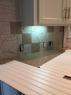 the kitchen counter is being installed in preparation for tile work on the backsplash