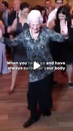 an older woman dancing on the dance floor