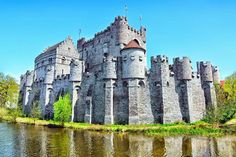 an old castle sitting next to a body of water