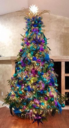 a brightly colored christmas tree in the middle of a living room with lights on it