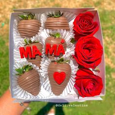 chocolate covered strawberries and roses in a box with the word ma written on them