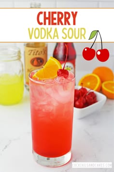 a red drink with oranges and cherries in the background