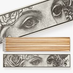 two matchesticks next to an image of a woman's face and flowers