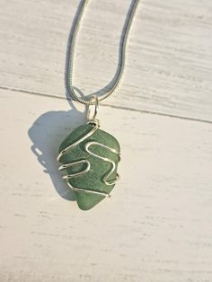 This beautiful piece of green sea glass comes from the Massachusetts coast. It is wire wrapped to create a beautiful one of a kind necklace. This piece of sea glass will look beautiful with any outfit and is sure to start a conversation. It's perfect for anyone who loves the beach! It would make a great gift for brides, bridesmaids, grads, moms...just about anyone, including yourself! This necklace comes with a sterling silver chain in your choice of length (either 18" or 20"). Like all of my je Green Recycled Glass Necklaces For Jewelry Making, Wire Wrapped Silver Sea Glass Necklaces, Silver Sea Glass Necklace With Wire Wrapped Detail, Wire Wrapped Silver Necklace With Sea Glass, Green Glass Wire Wrapped Necklaces, Green Glass Wire Wrapped Necklace, Green Sea Glass Necklaces For Jewelry Making, Green Sea Glass Necklace For Jewelry Making, Wire Wrapped Green Glass Jewelry