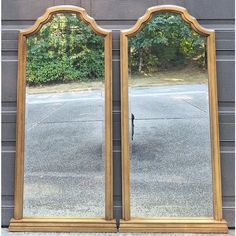 two large mirrors sitting next to each other