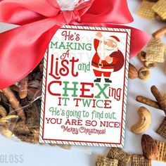 a christmas gift tag is tied with a red ribbon and surrounded by cheery pretzels