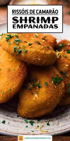 fried shrimp empanadas on a white plate with parsley garnish