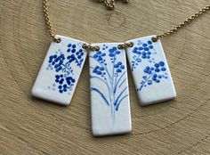 Necklace of three Spanish ceramic pendants hand-painted with the Talavera technique, in white and blue tones, with a floral theme in three blocks. It is articulated to form the drop of the necklace with a very resistant, medium-thick golden stainless steel chain. They form a precious, unique and special piece. Excellent gift for those who appreciate special things. WHAT IS SPECIAL ABOUT OUR PRODUCTS. - - They are precious pieces of ceramic jewelry made by hand with the traditional TALAVERA technique, which consists of decorating on white enamel on a cover, in the second burning. The area of Talavera de la Reina and Puente del Arzobispo in the province of Toledo, Spain has a centuries-old tradition of this type of ceramic decoration, for which UNESCO in 2019 has declared INTANGIBLE CULTURAL Spanish Crafts, Ceramic Pendants, Spanish Tiles, Art Nouveau Necklaces, Spain Spanish, Toledo Spain, Ceramic Decoration, Cardboard Jewelry Boxes, Spanish Tile