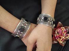 * This traditional craft is embellished with black stones and intricate carved designs, inspired by the true Afghani ornaments. The light in weight, yet exclusive bracelet would add an ethnic touch to your attire. The pick tiny stones are complimenting the tribal style of the hand accessory. You can pair this elegant ornament with any traditional or trendy attire, as per your liking. Note: The product is handmade, so slight change might occur in the actual product. Silver Bohemian Beaded Bracelets For Festive Occasions, Bohemian Silver Beaded Bracelets For Festive Occasions, Bohemian Oxidized Bangle Jewelry, Bohemian Bangle Jewelry With Oxidized Finish, Bohemian Bangle With Oxidized Finish, Bohemian Bangle For Rituals, Bohemian Oxidized Bangle For Festivals, Traditional Metal Beaded Bracelets For Gifts, Traditional Metal Beaded Bracelets As Gift