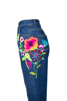 a woman's jeans with embroidered flowers on the bottom and side, back view