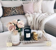 a living room filled with lots of furniture and flowers on top of a coffee table