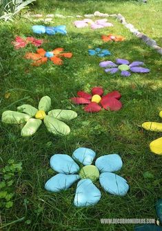 colorfully painted flowers in the grass on a sunny day