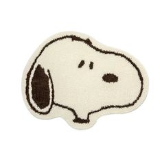 a white and brown rug with a dog's face drawn on the front of it