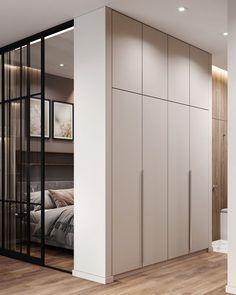 a bedroom with white walls and wooden floors has sliding doors that open to reveal a bed