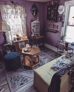 a living room with purple walls and furniture in the corner, including a coffee table