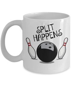 a white coffee mug with bowling balls and the words split happens on it