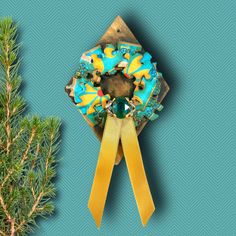 an ornament made out of doughnuts on top of a pine tree