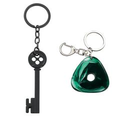 two keychains one with a green piece and the other has a black object