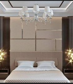 a large bed sitting under a chandelier next to a wall with lights on it