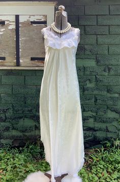 Vintage embossed cream nightgown, Carole Hochman Bonwit Teller. This vintage cream nightgown features a sleeveless V-neck style top trimmed in white lace with floral embellishments on the lace and ribbon straps, 2 side slits, and lace trim around the hem. Great condition; no flaws to note.  Original label tag attached and reads Carole Hochman  Bonwit Teller Size small; see measurements below: Measurements:   Chest (taken with garment lying flat from pit-to-pit): 15" Waist (taken with garment lying flat from side seam-to-seam): 17" Length from middle back to bottom: 44" All the items I list in my store are vintage or antique. Some treasures will show signs of wear or age, and I will always do my best to list any flaws, marks or honest repairs.  Please carefully study all the item photos for Feminine Cream Nightgown With Lace Trim, White Lace Nightgown With Lace Trim, Cream Lace Trim Sleepwear For Bedtime, White Lace Sleepwear For Home, Cream Lace Sleepwear For Bedtime, Sleeveless Lace Nightgown With Delicate Detail, White Lace Trim Nightgown For Home, White Sleeveless Sleepwear With Delicate Lace, Sleeveless Cream Nightgown For Wedding