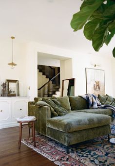 a living room filled with furniture and a stair case