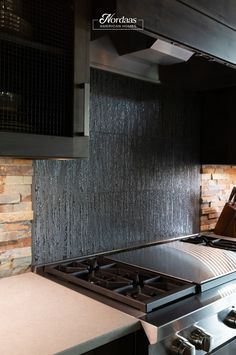 a stove top oven sitting inside of a kitchen next to a wall mounted range hood