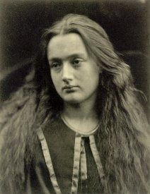 an old black and white photo of a woman with long hair