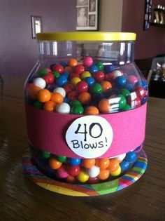 a glass jar filled with lots of colorful balls