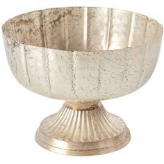 a silver bowl sitting on top of a metal stand