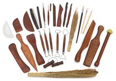 an assortment of wood carving tools including knifes, spoons and other wooden objects