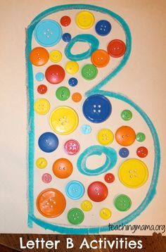 the number six made out of buttons on a white surface with text that reads letter b activities