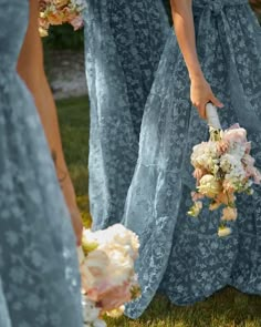 the bridesmaids are holding their bouquets and walking together in blue lace dresses