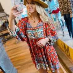 This Tunic Top Is Perfect To Just Throw On With Your Favorite Pair Of Jeans And Call It A Day! This Tunic Top Features A V-Neck, Bohemian Floral Print Top Designed With A Flowing Fit. Bust Lying Flat: Small-18, Medium-19", Large-20" Length Lying Flat: Small-34", Medium-35", Large-36" 100% Rayon Red Bohemian V-neck Mini Dress, Bohemian Red V-neck Mini Dress, Casual Red V-neck Boho Dress, Red Mini Dress With Vibrant Print, Printed Red Dress For Brunch, Red Printed Dresses For Brunch, Red Printed Dress For Brunch, Red Bohemian Mini Dress For Brunch, Red Bohemian Mini Dress