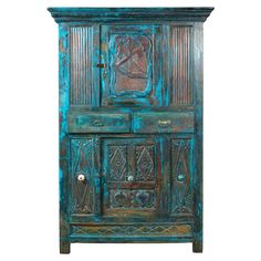 an old wooden armoire with carvings on the front and sides, painted in blue