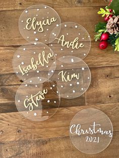 four personalized acrylic decals on top of a wooden table with christmas decorations