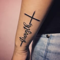 a person with a cross tattoo on their arm