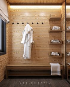 a bathroom with wooden walls and shelves filled with white bathrobe, towels and other items