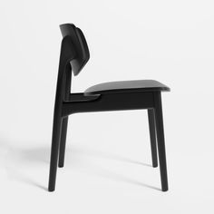 a black chair sitting on top of a white floor