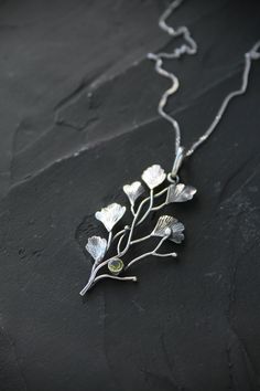 ITEM DESCRIPTION: The size H 5 cm x W 3 cm (2 x 1 inch). Weight - 3 g. Maidenhair fern is gentle and very beautiful plant. So it inspired me to create this unusual plant necklace. It looks natural and elegant at the same time. I made it of sterling silver and peridot. Tiny leaves repeat the natural shape and texture. This jewelry will not go unnoticed and will bring you many compliments. Ooak jewelry made by eco-friendly materials. This handmade necklace will come to you in a gift box - ready fo Silver Leaf-shaped Nature-inspired Necklace, Nature-inspired Leaf Shaped Sterling Silver Necklace, Nature-inspired Sterling Silver Leaf Necklace, Nature-inspired Sterling Silver Pendant Necklace, Delicate Green Sterling Silver Necklace, Delicate Green Sterling Silver Necklaces, Ursula Jewelry, Sterling Silver Leaf Necklace, Plant Necklace