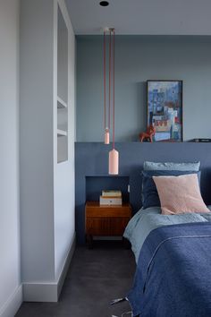 a bed room with a neatly made bed and a night stand